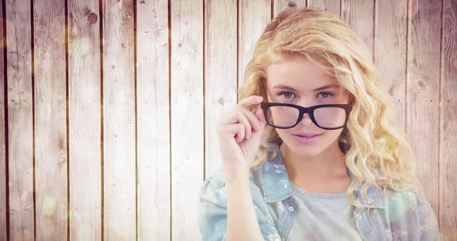 Portrait of businesswoman wearing eyeglasses posing  against wooden planks