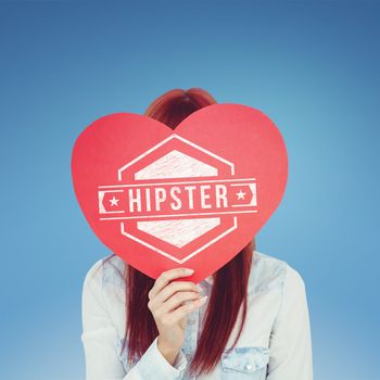 Attractive hipster woman behind a red heart against blue sky
