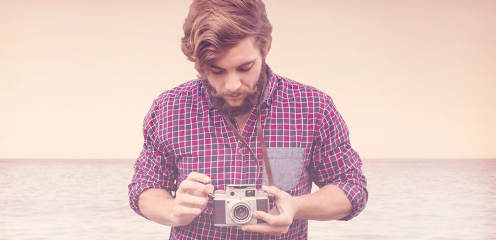 Hipster using camera against beautiful day in the water