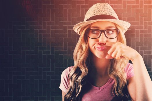 A beautiful hipster having a fake mustache  against textured background