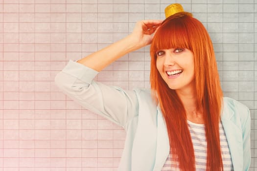 Smiling hipster woman wearing hat party against textured background