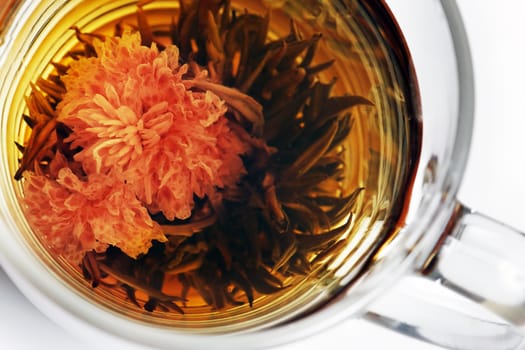 Cup with blooming tea close up