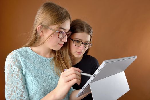 two young teenage girls with a tablet