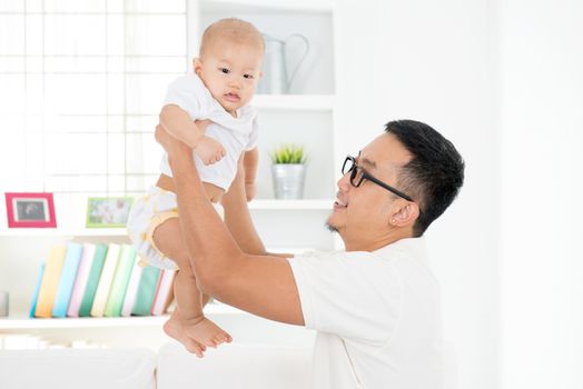 Father and baby boy playing at home. Asian family lifestyle indoors.