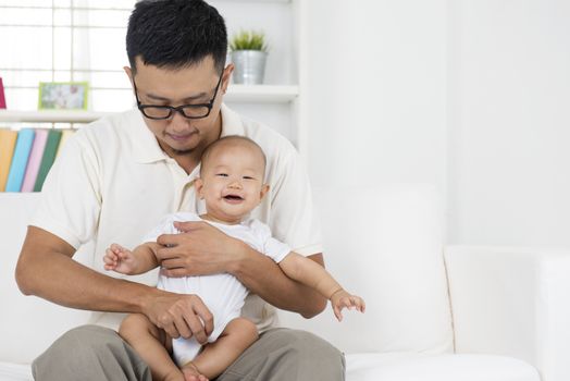 Father and baby boy playing at indoors. Asian family lifestyle at home.