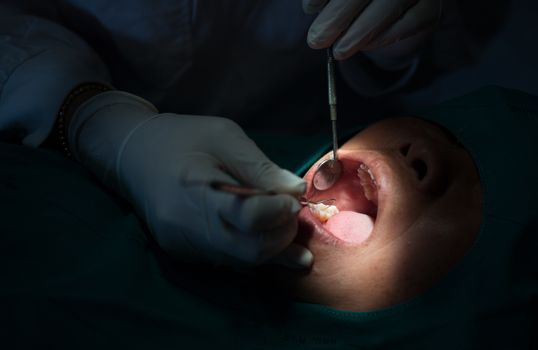 Dentist examining a patients teeth in  dental clinic