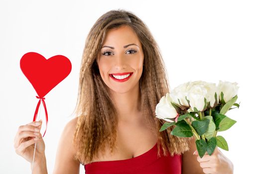 Portrait of a beautiful smiling girl holding a red heart and bouquet white roses. Looking at camera.