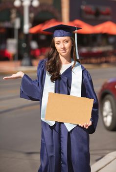 Grinning woman with hand out holding cardboard sign