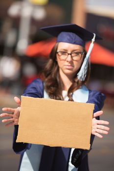 Disappointed young woman holding blank cardboard sign