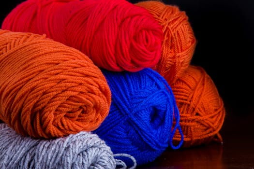 Yarn that is sitting in buddles waiting for someone to use them for homemade goods.