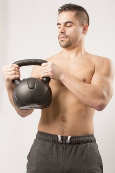 Sexy Young fashion sport man, fitness muscle model guy making push ups exercise over white background.