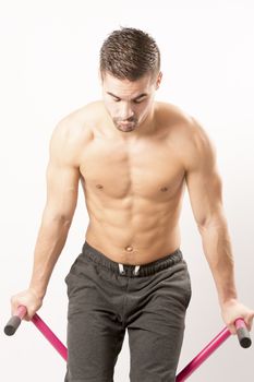 Sexy Young fashion sport man, fitness muscle model guy making push ups exercise over white background.