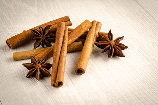 Cinnamon and anise on the wooden background