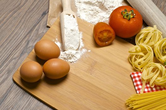 Still life with raw homemade pasta and ingredients for pasta