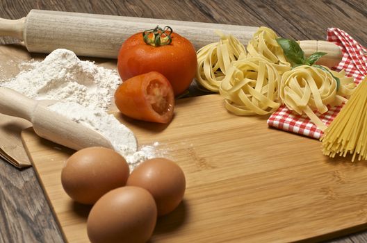 Still life with raw homemade pasta and ingredients for pasta