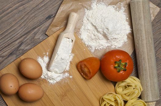 Still life with raw homemade pasta and ingredients for pasta