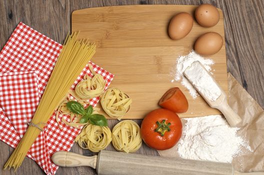 Still life with raw homemade pasta and ingredients for pasta