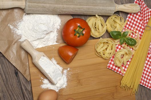 Still life with raw homemade pasta and ingredients for pasta