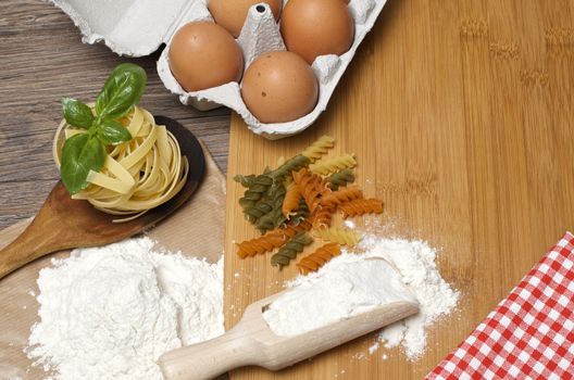 Still life with raw homemade pasta and ingredients for pasta