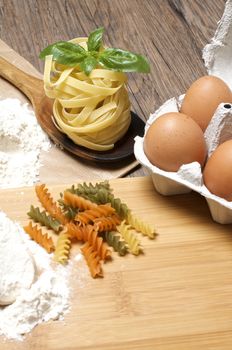 Still life with raw homemade pasta and ingredients for pasta