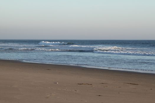 Sunset time at Ormond Beach with beautiful sky and blue water