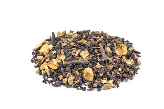 Biological mixed brown tea with herbs like cloves, apple and cinnamon isolated on white background