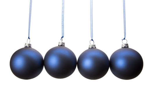 Four blue christmas baubles hanging in horizontal row isolated on white background