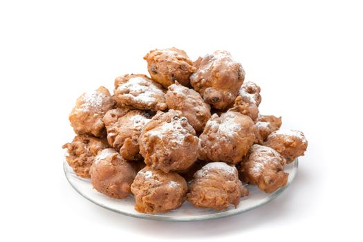 Heap of sugared fried fritters or oliebollen on scale isolated on white background