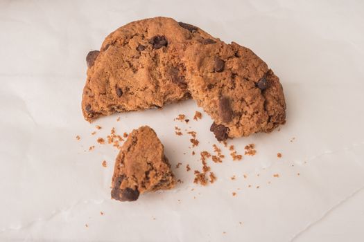 Chocolate chip cookies on a white wooden table background. Vintage look.