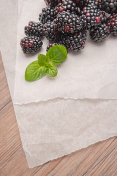 Ripe sweet blackberries on wood table background