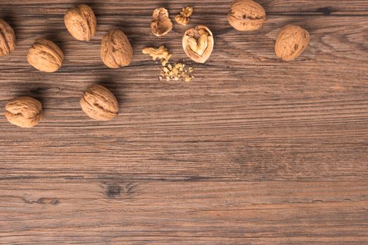 Nuts set background with copyspace on a wood background. Top view with copy space