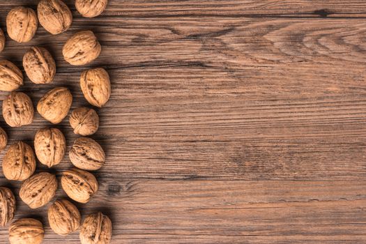 Nuts set background with copyspace on a wood background. Top view with copy space