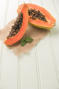 Sliced fresh papaya on wooden background. Top view with copy space