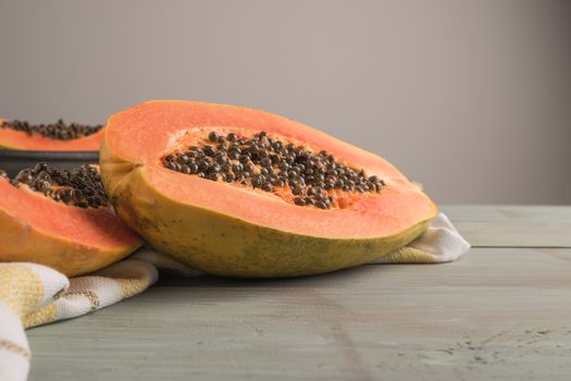 Sliced fresh papaya on wooden background. Top view with copy space