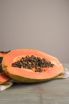 Sliced fresh papaya on wooden background. Top view with copy space