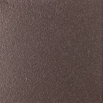 Background texture of a shiny metal sheet with a rough stippled textured surface reflecting light. Metal texture
