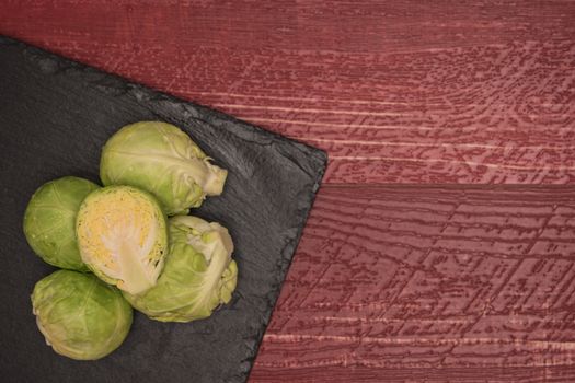 Fresh brussel sprouts on slate. Top view with copy space.