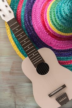 Mexican background. Sombrero and guitar on rustic wooden background. Top view with copy space