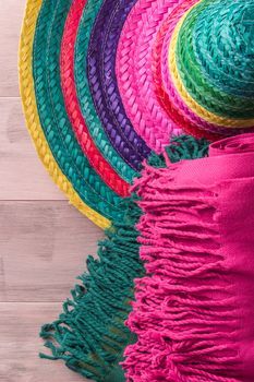 Mexican background. Sombrero and blankets on rustic wooden background. Top view with copy space