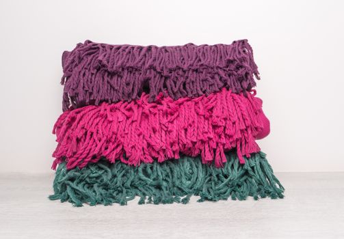 Collection of woolen soft and worm scarf on rustic wooden background. Top view with copy space