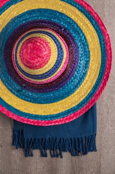 Mexican background. Sombrero and blankets on rustic wooden background. Top view with copy space