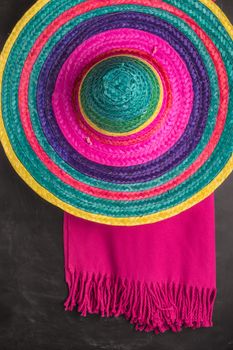 Mexican background. Sombrero and blankets on rustic slate background. Top view with copy space