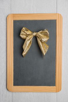 Blank rustic Christmas chalkboard slate with lace ready for your seasonal greetings. Top view with copy space 