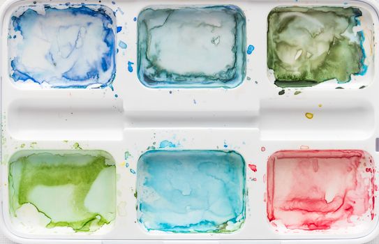 The palette of watercolor paint. Background image. Splashes of colorful. Top view with copy space.