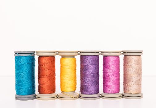 Multi-colored threads, sewing kit, a set of tailor on white background