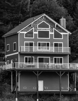 Coeur d'Alene, Idaho, USA-July 9, 2015: A house with interesting architecture sits on the rocks overlooking Lake Coeur d'Alene in the summer.