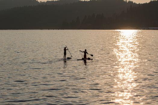 Sunset on Lake Coeur d'Alene in Idaho. Two paddle boarders on the lake enjoying a summer afternoon.
Photo taken on: July 09th, 2015