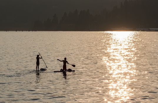 Sunset on Lake Coeur d'Alene in Idaho. Two paddle boarders on the lake enjoying a summer afternoon.
Photo taken on: July 09th, 2015
