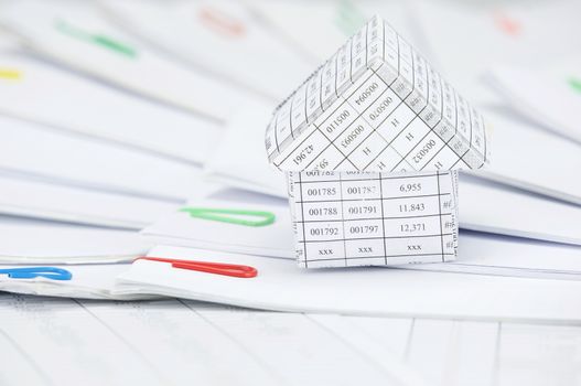 Close up house with step of paperwork with colorful paperclip place curve on finance account.