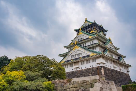 Osaka castle in cloudy sky before the rain fall down in Osaka, Japan.